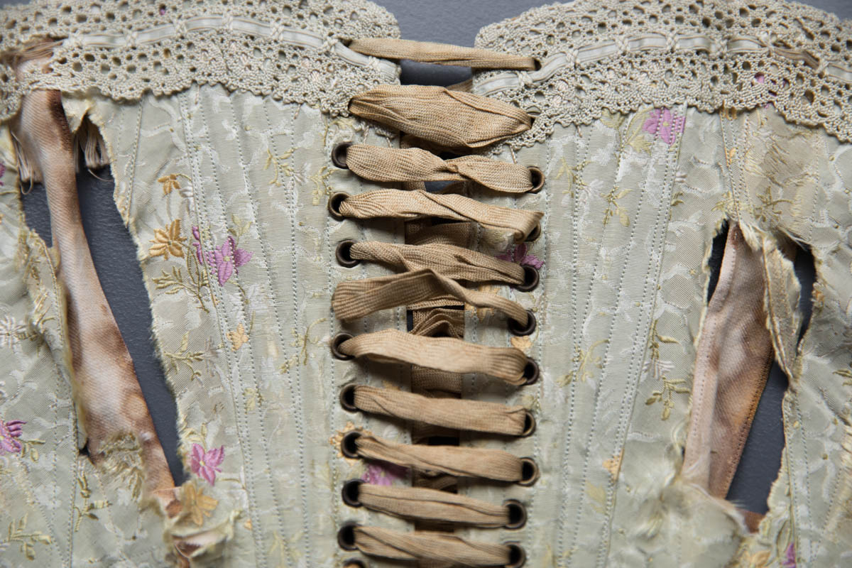 Silk Brocade Midbust Corset With Ribbon Slot Crochet Lace Trim, c. 1900s. The Underpinnings Museum. Photography by Tigz Rice