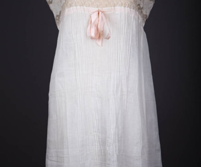 Pleated Cotton Slip With Moon Embroidery, Lace Trim & Silk Ribbon Straps, c. 1910s, Great Britain. The Underpinnings Museum. Photography by Tigz Rice.