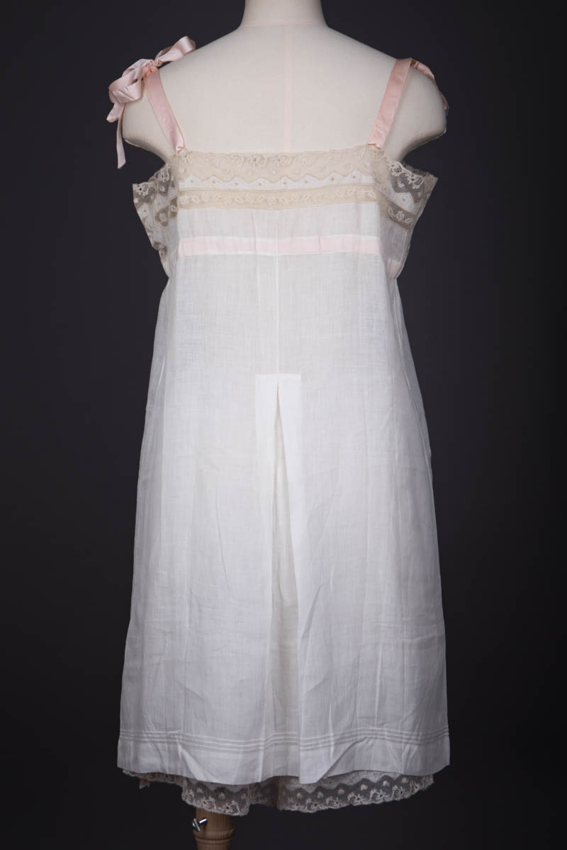 Pleated Cotton Slip With Moon Embroidery, Lace Trim & Silk Ribbon Straps, c. 1910s, Great Britain. The Underpinnings Museum. Photography by Tigz Rice.