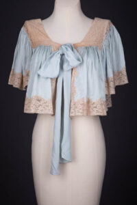 Pale Blue Silk Bed Jacket With Lace Trim & Bow Tie, c. 1930s. The Underpinnings Museum. Photography by Tigz Rice.
