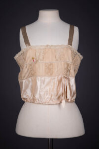 Peach Silk Satin, Pintucked Silk Georgette, Insertion Lace & Ribbonwork Corset Cover By Chamberlin-Johnson-DuBose Co., c. 1920s, USA. The Underpinnings Museum. Photography by Tigz Rice.