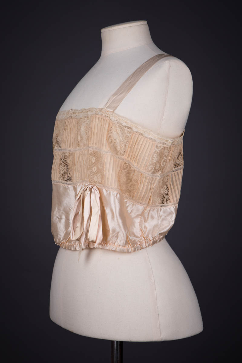 Peach Silk Satin, Pintucked Silk Georgette, Insertion Lace & Ribbonwork Corset Cover By Chamberlin-Johnson-DuBose Co., c. 1920s, USA. The Underpinnings Museum. Photography by Tigz Rice.