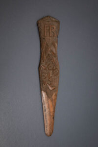 Tapered Carved Wooden Busk With Floral Relief, late 18th century. The Underpinnings Museum. Photography by Tigz Rice.