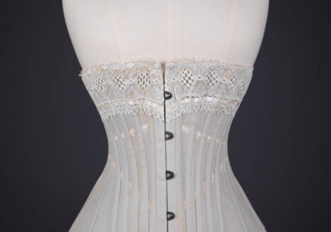 Grey Herringbone Coutil Corset With Ribbon Slot Lace Trim & Woven Ribbon Embellishment By Corset Cigno, c. 1900s, Italy. The Underpinnings Museum. Photography by Tigz Rice.