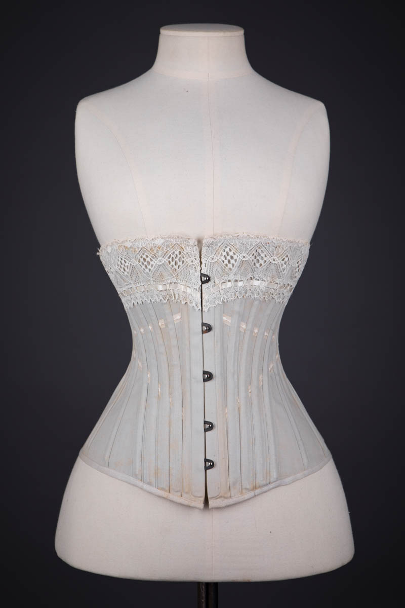 Grey Herringbone Coutil Corset With Ribbon Slot Lace Trim & Woven Ribbon Embellishment By Corset Cigno, c. 1900s, Italy. The Underpinnings Museum. Photography by Tigz Rice.