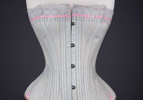 Grey Cotton Corset With Contrast Pink Flossing Embroidery And Lace Ribbon Slot Trim By Fitu Corsets, c. 1900s, Great Britain. The Underpinnings Museum. Photography by Tigz Rice.
