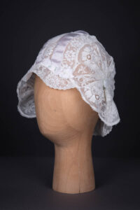 White Filet Style Lace & Lilac Silk Ribbon Boudoir Cap, c. 1920s. The Underpinnings Museum. Photography by Tigz Rice