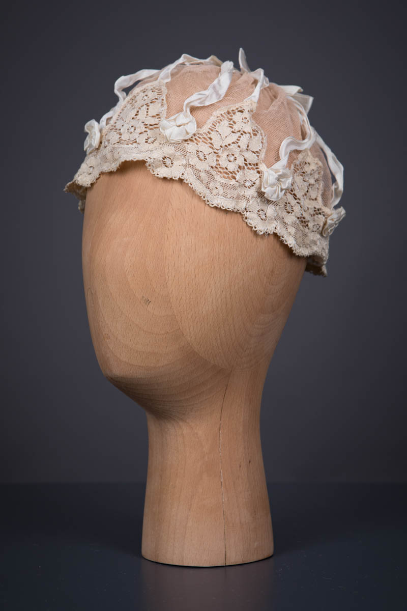 Beige Cotton Tulle Boudoir Cap With Ribbon & Machine Lace Trim, c. 1920s. The Underpinnings Museum. Photography by Tigz Rice.