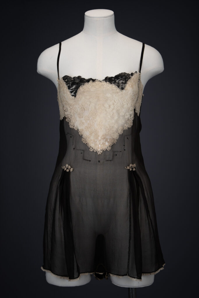 Black Silk Step In With Blonde Lace Appliqué By Chas A. Stevens & Bros, c. 1920s, USA. The Underpinnings Museum. Photography by Tigz Rice. Black Silk Step In With Blonde Lace Appliqué By Chas A. Stevens & Bros, c. 1920s, USA. The Underpinnings Museum. Photography by Tigz Rice.