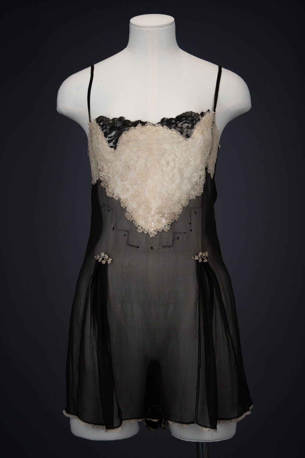 Black Silk Step In With Blonde Lace Appliqué By Chas A. Stevens & Bros, c. 1920s, USA. The Underpinnings Museum. Photography by Tigz Rice. Black Silk Step In With Blonde Lace Appliqué By Chas A. Stevens & Bros, c. 1920s, USA. The Underpinnings Museum. Photography by Tigz Rice.